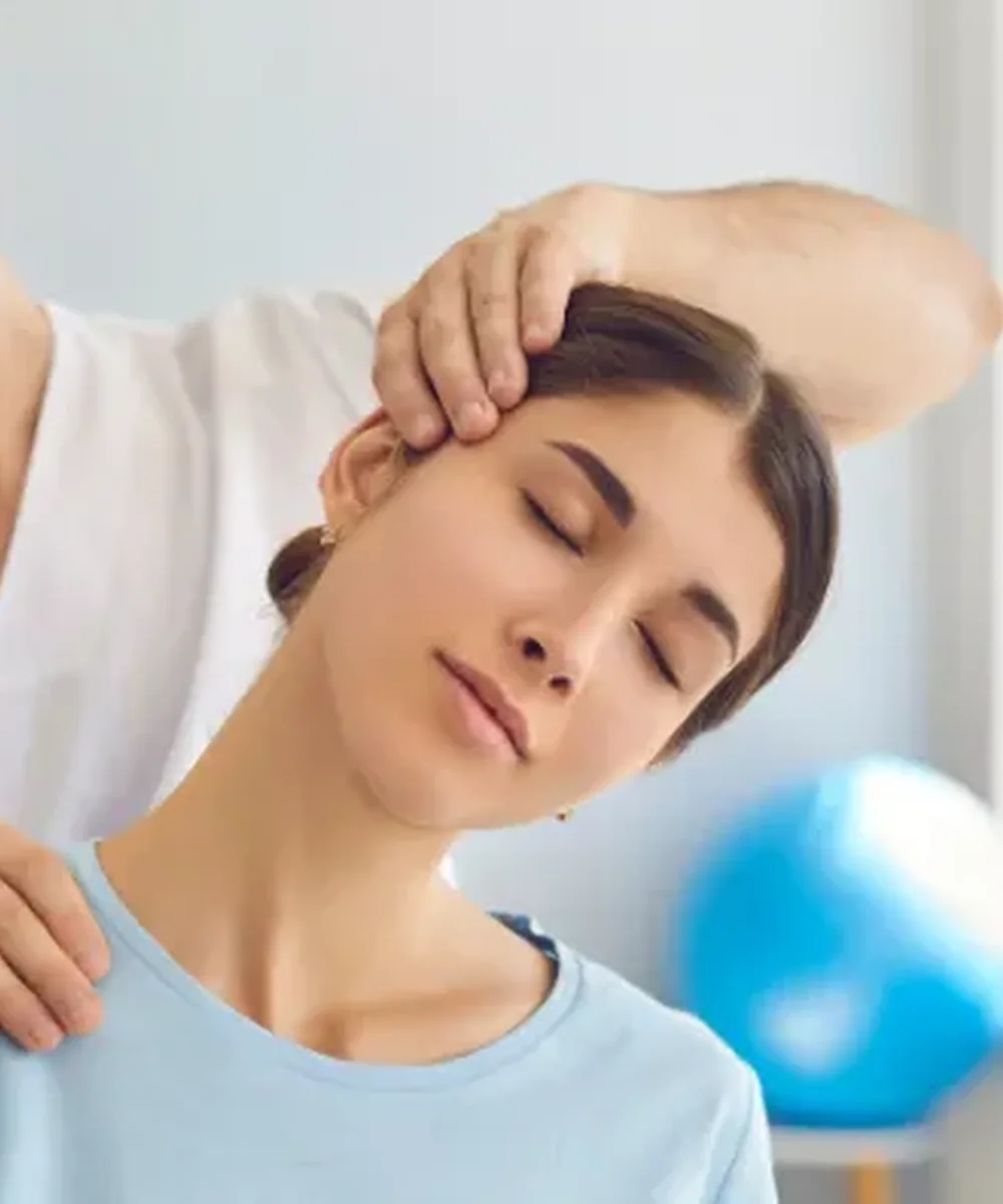 A Doctor of Physical Therapy evaluating neck pain and headaches at Kaizen Health and Wellness in Urbandale, IA