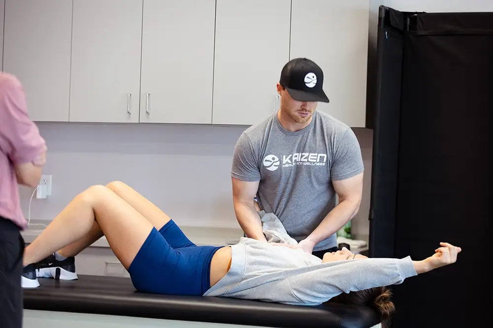 A Doctor of Physical Therapy working hands-on with a patient's core and trunk at Kaizen Health and Wellness in Urbandale, IA